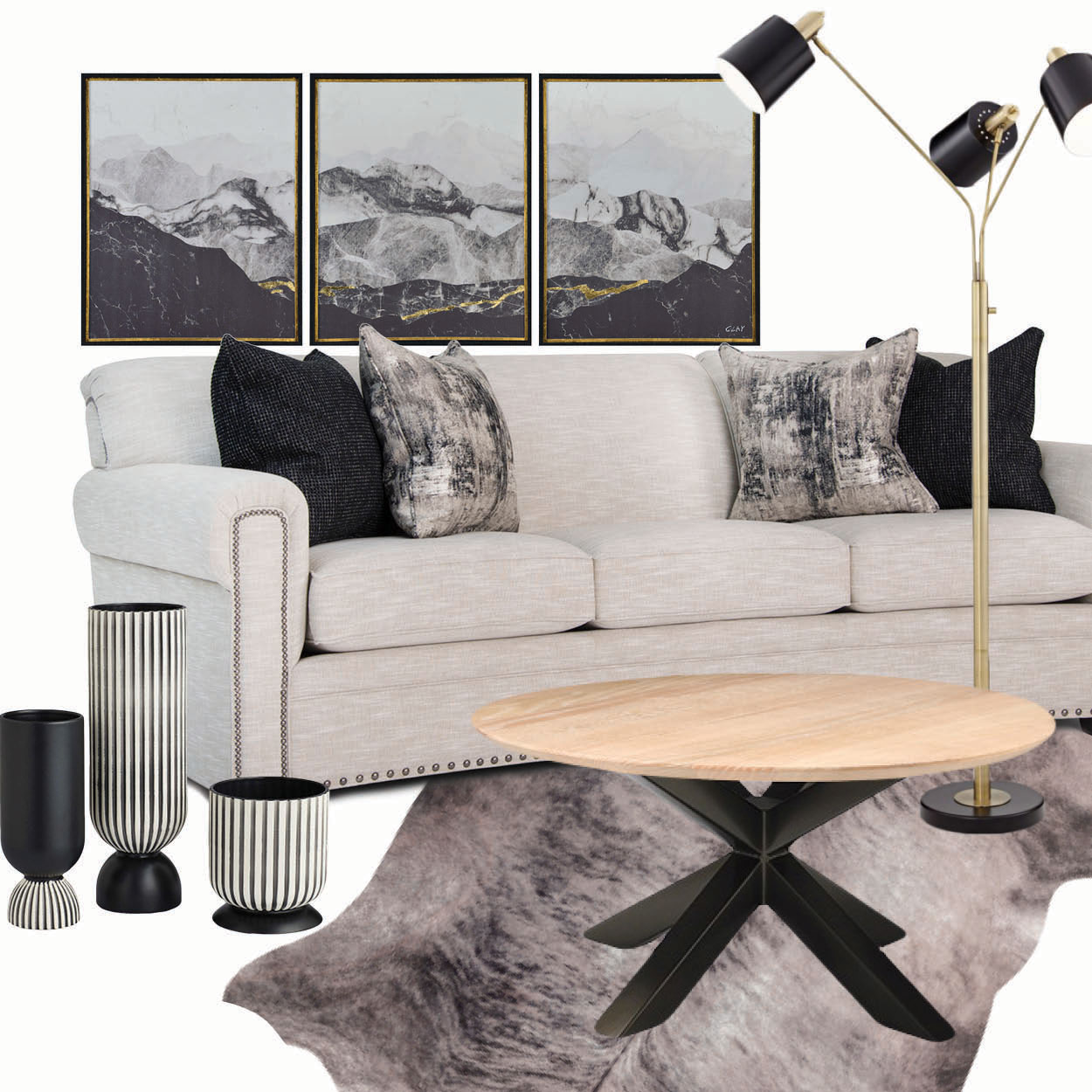 A white sofa with black and grey throw pillows sits atop a faux fur rug with various matching decor placed around it