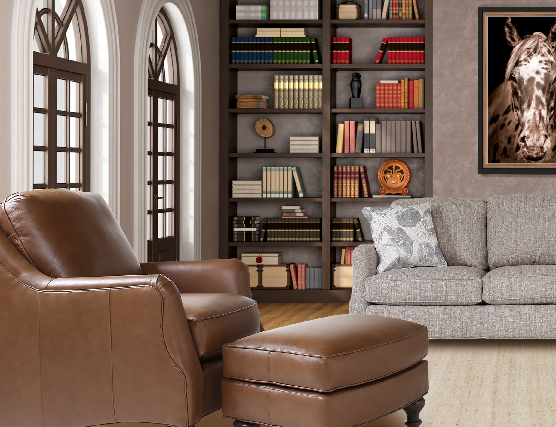 A cozy brown leather chair sits in the foreground complete with matching ottoman with a light grey sofa in the background sitting next to a fully stocked bookcase and below a painting of a horse