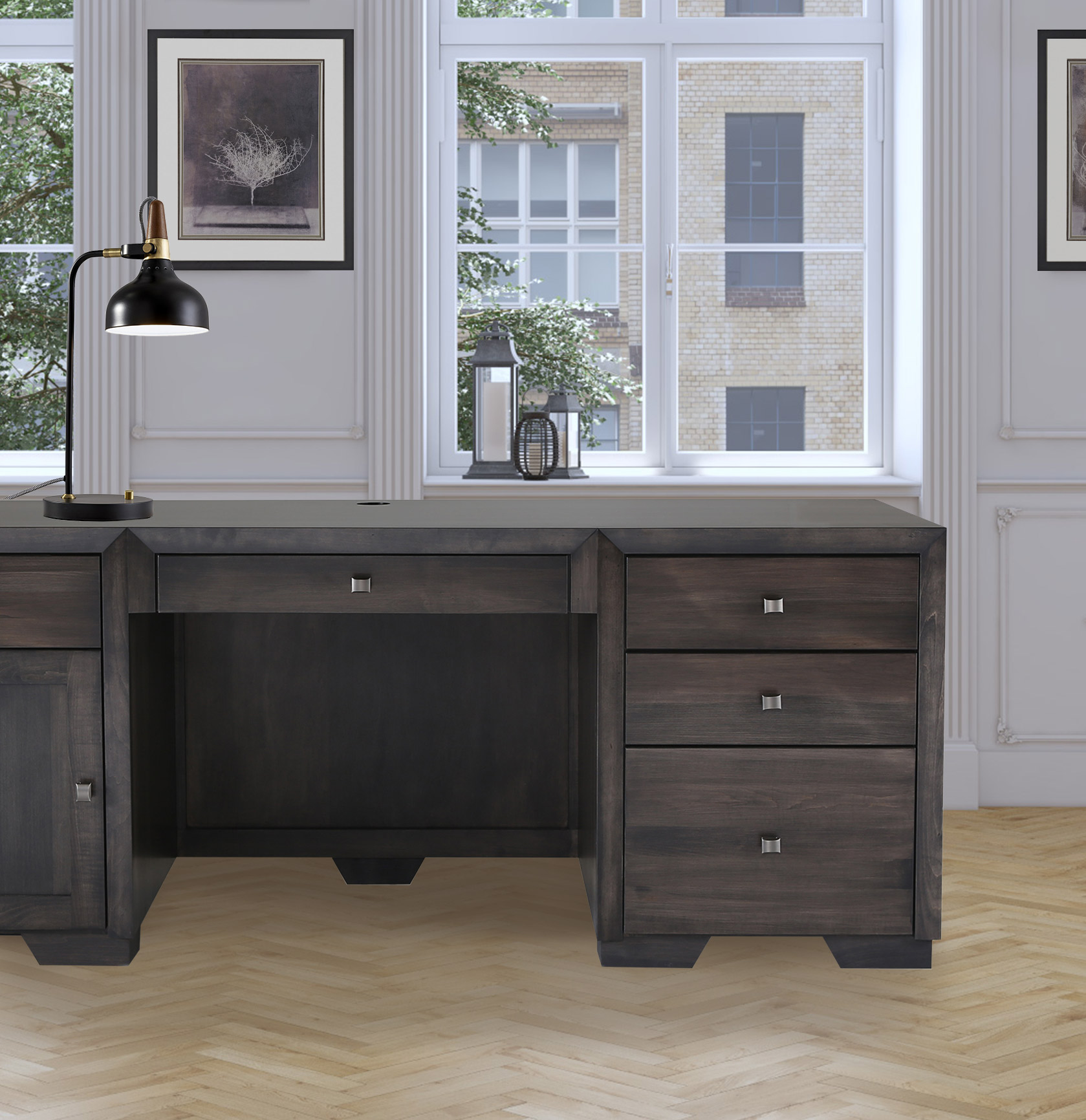 A modern desk with matching side cabinets and long center drawer in a dark brown sits in a high class office space at home.