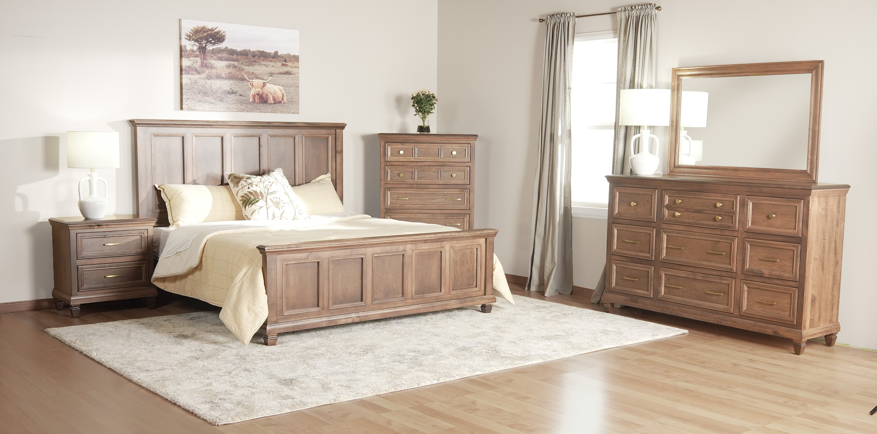 A fully complete and matching bedroom set sits in a master bedroom with a wooden floor all surrounding a king size bed.