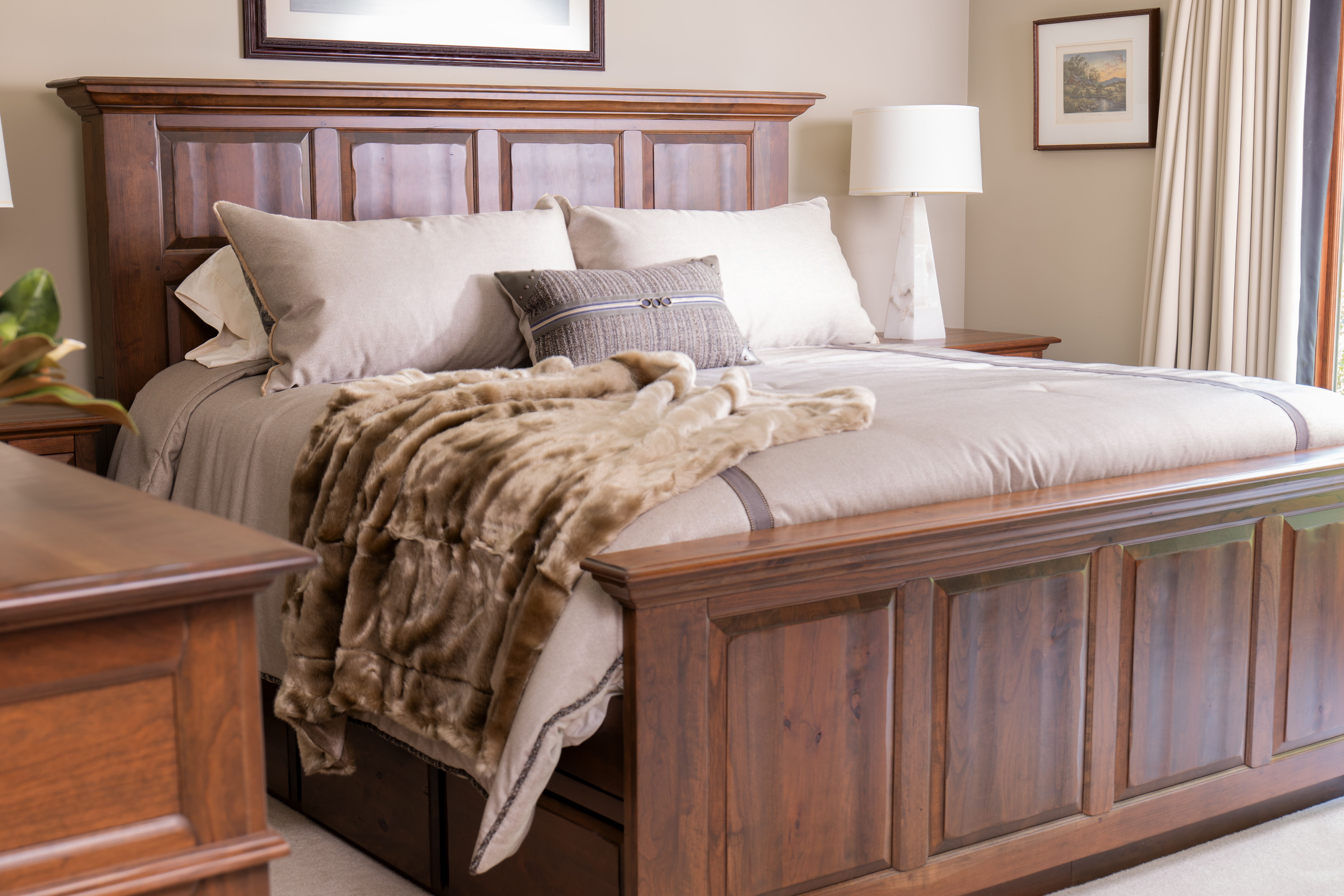 A large king size bed and matching bedroom suit demonstrate Artisanal Craftsmanship at Penny Mustard within a large master bedroom.