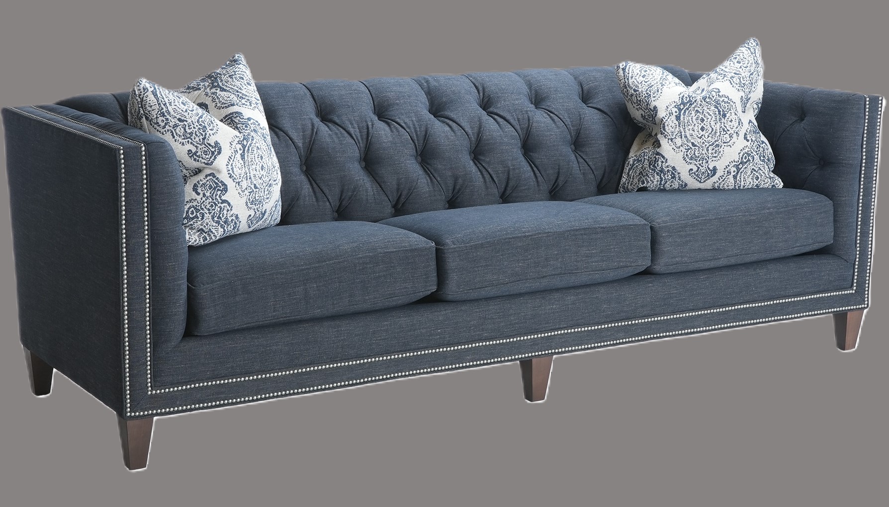 The Chesterfield Sofa at Penny Mustard sits against a dark grey background