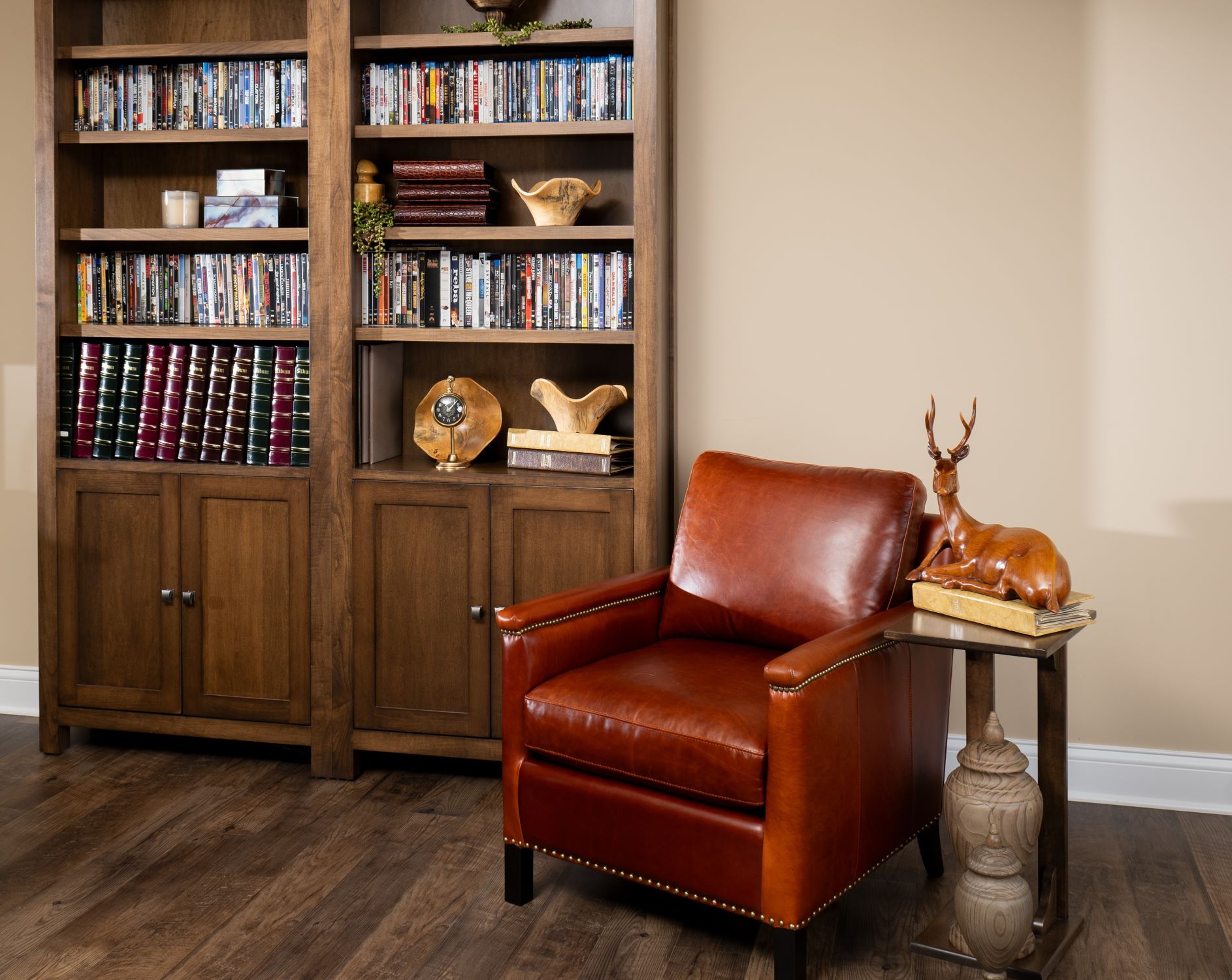 The Gould Chair & Sherwood Bookcase sit in a stylish office with various items of decor sitting on the shelves