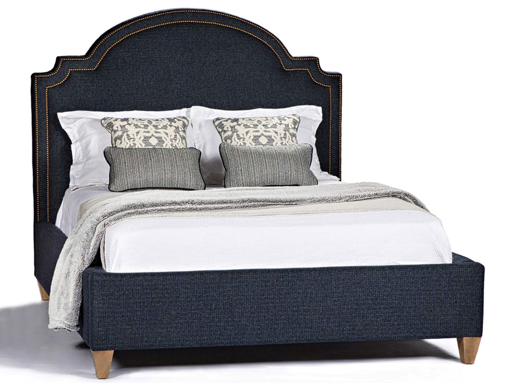 The Abigail Upholstered Bed in blue fabric with light wooden legs sits on a field of white